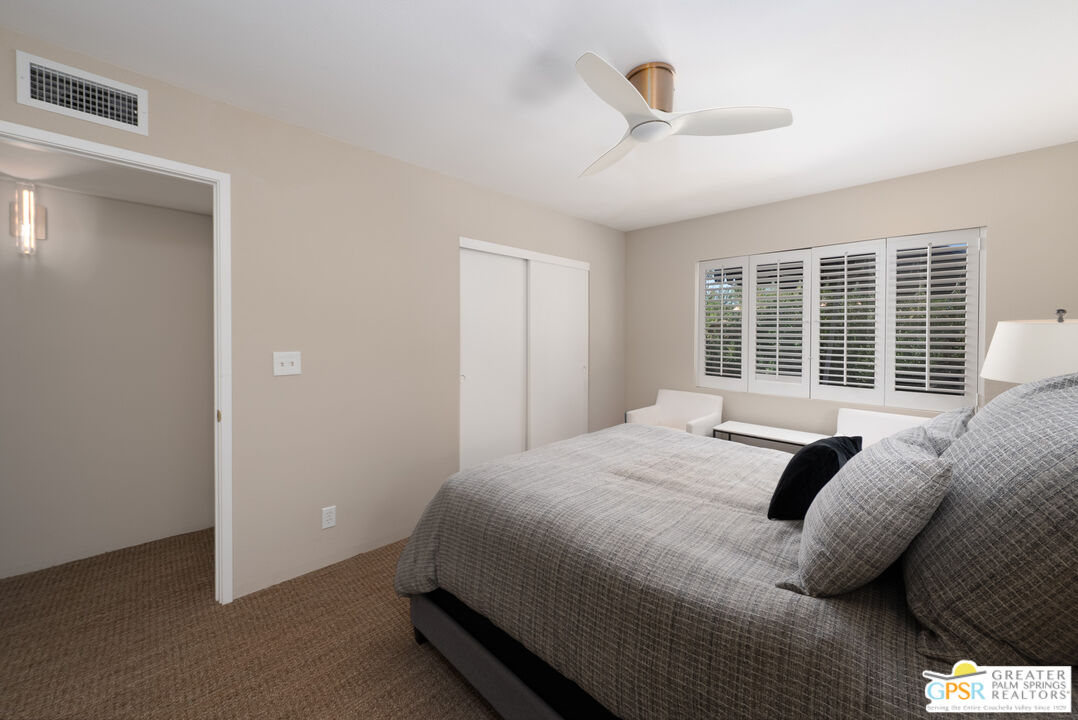566 North Sunset Way Palm Springs, CA 92262 - Photo 18 of 39 a bedroom with a bed and a large window