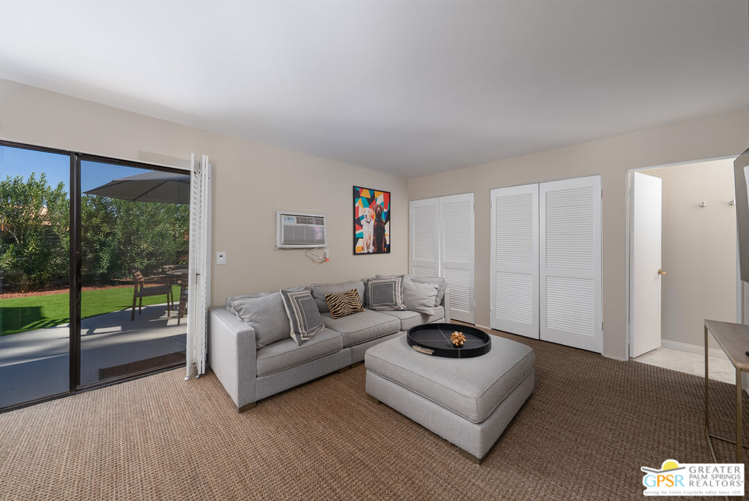 566 North Sunset Way Palm Springs, CA 92262 - Photo 24 of 39 a living room with furniture and a large window