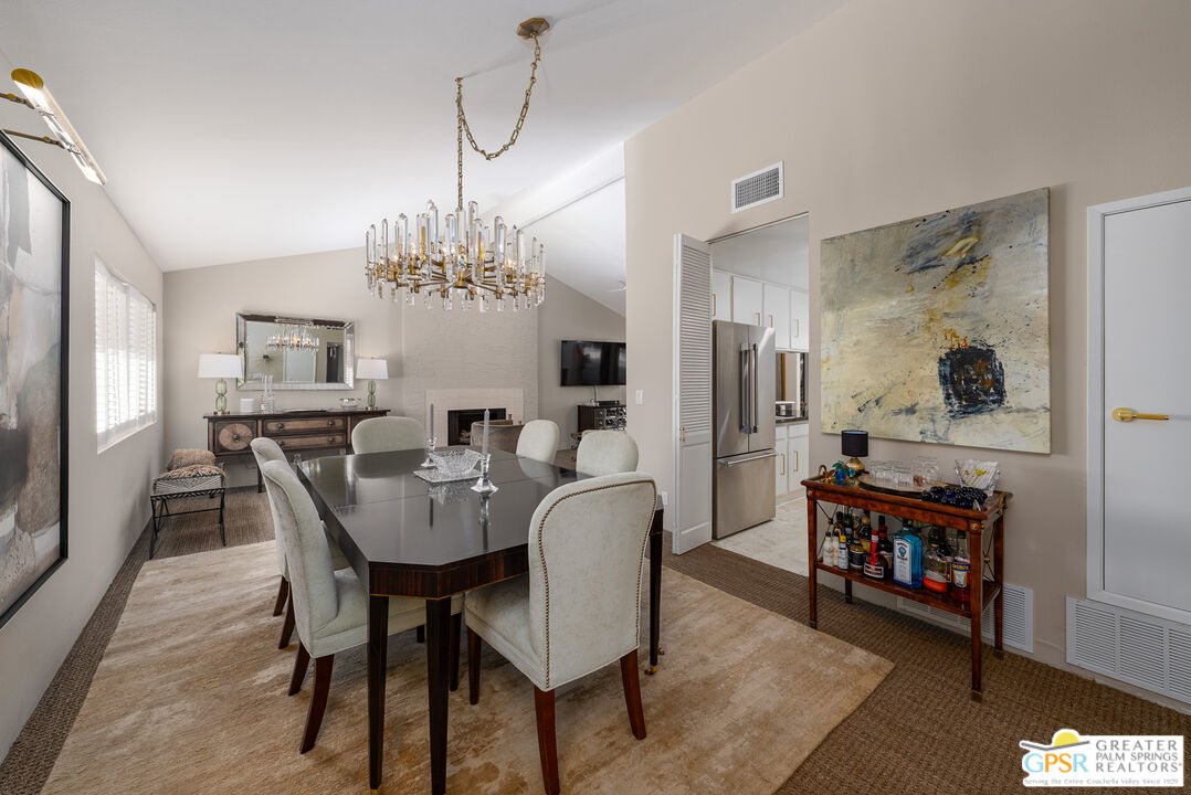 566 North Sunset Way Palm Springs, CA 92262 - Photo 3 of 39 a view of a dining room with furniture and wooden floor