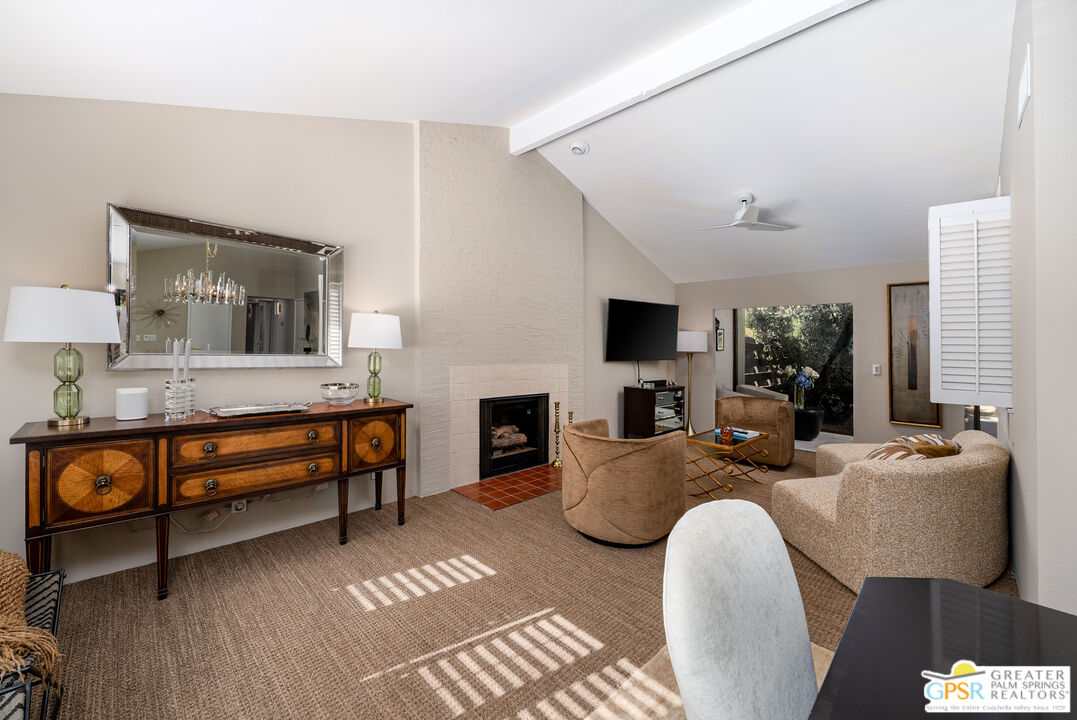 566 North Sunset Way Palm Springs, CA 92262 - Photo 4 of 39 a living room with fireplace furniture and a flat screen tv