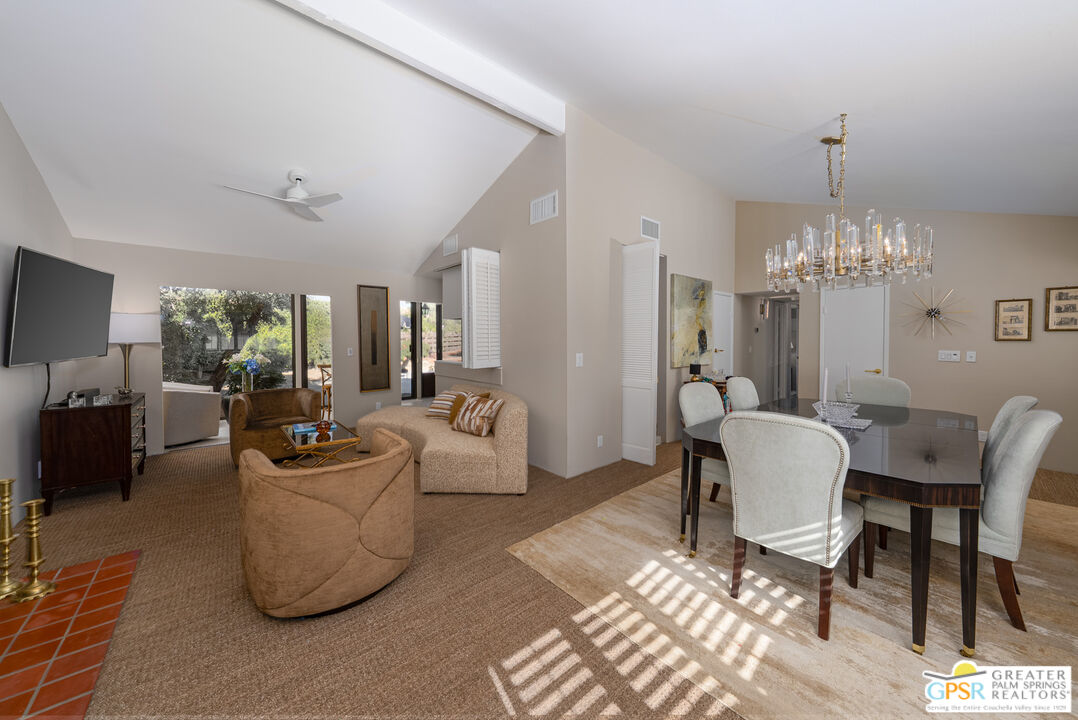 566 North Sunset Way Palm Springs, CA 92262 - Photo 5 of 39 a living room with furniture a chandelier and a dining table