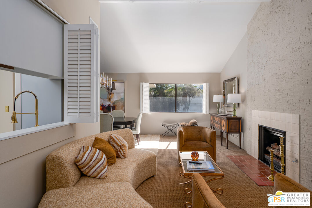 566 North Sunset Way Palm Springs, CA 92262 - Photo 6 of 39 a living room with furniture and a fireplace