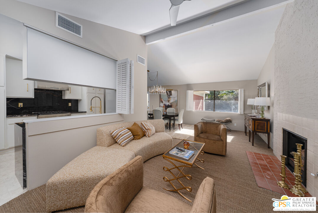 566 North Sunset Way Palm Springs, CA 92262 - Photo 7 of 39 a living room with furniture and a fireplace