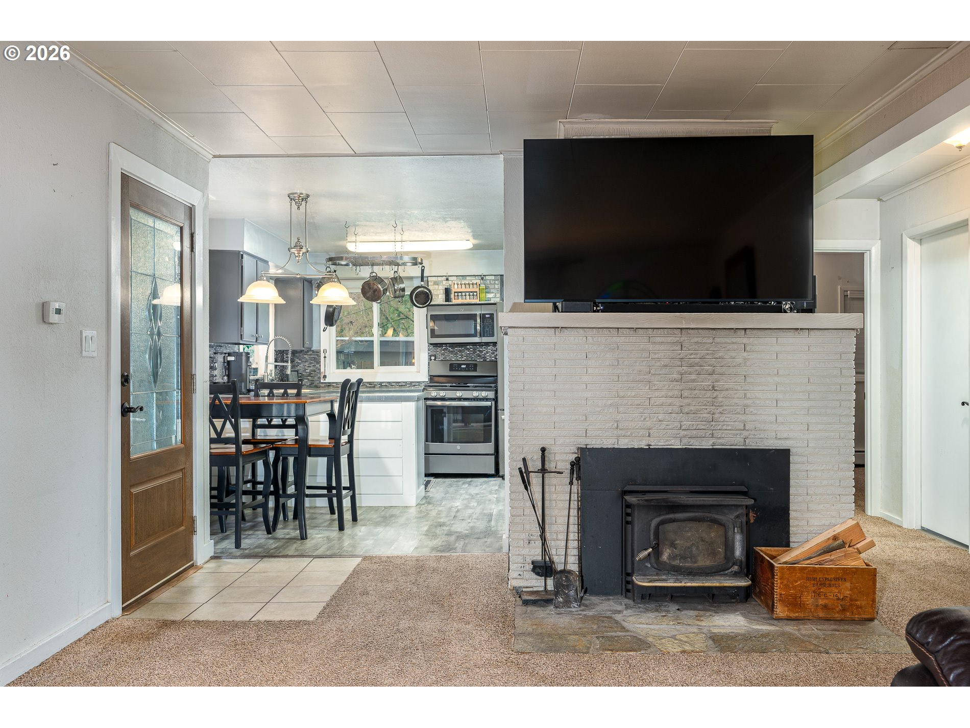 2685 Southwest 89th Avenue Portland, OR 97225 - Photo 13 of 37 a living room with furniture a flat screen tv and a fireplace