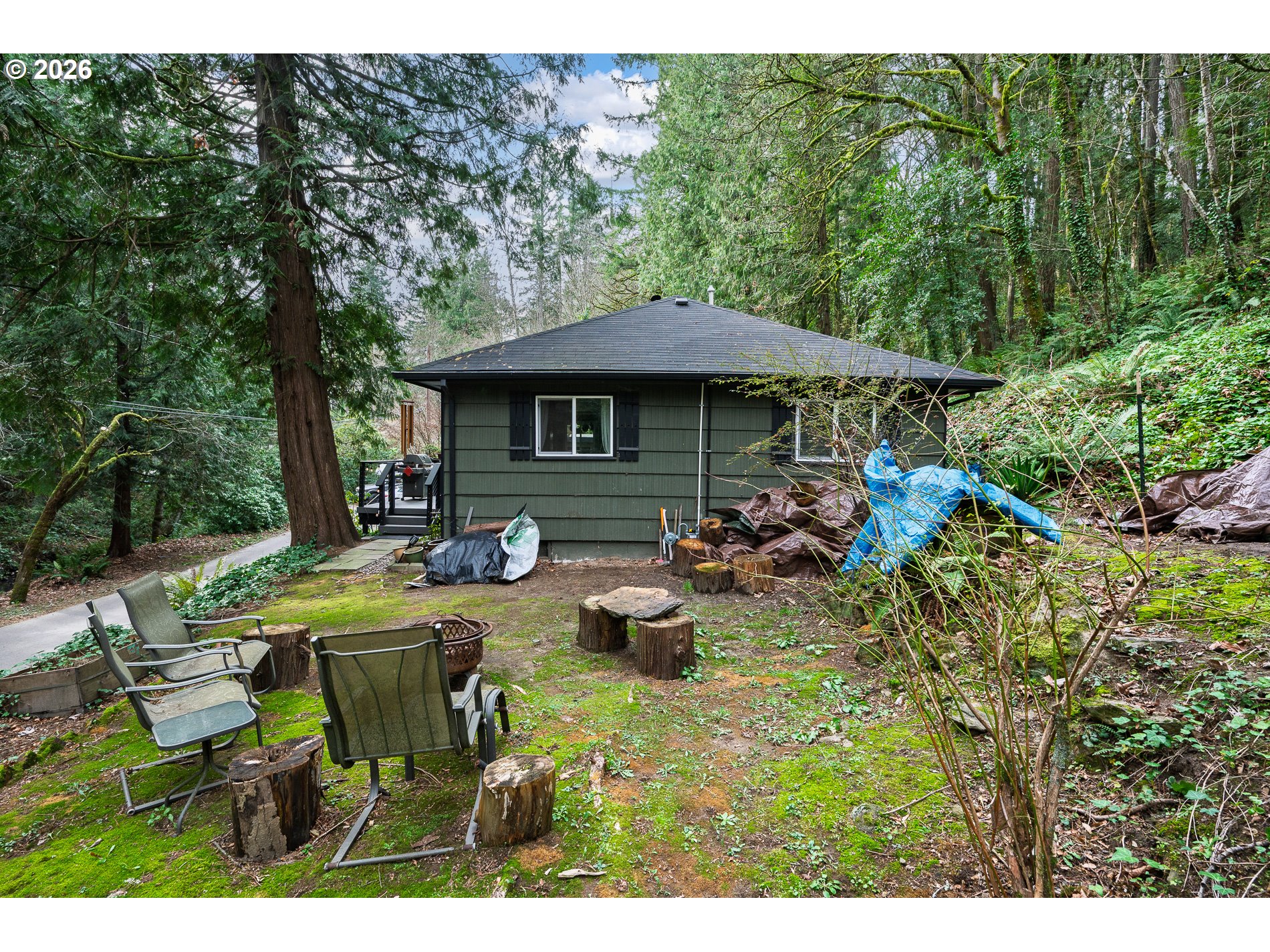 2685 Southwest 89th Avenue Portland, OR 97225 - Photo 37 of 37 a view of a patio with table and chairs potted plants with large tree