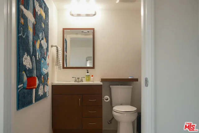 a bathroom with a toilet sink and mirror