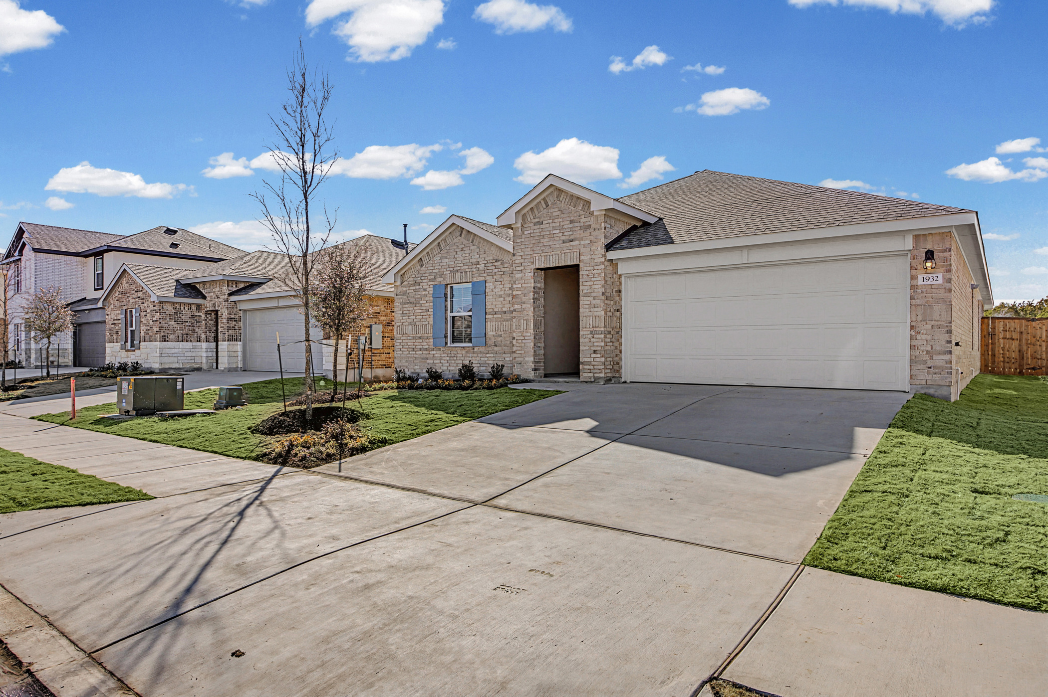 1932 Bandito Bluff Pass Leander, TX 78641 - Photo 2 of 21 a front view of a house with a yard and garage
