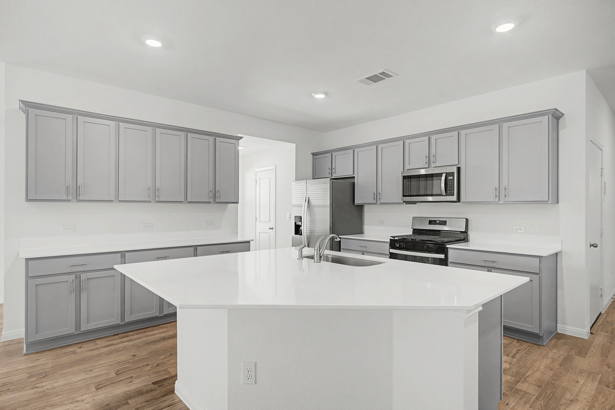1932 Bandito Bluff Pass Leander, TX 78641 - Photo 3 of 21 a kitchen with stainless steel appliances a refrigerator stove microwave and sink