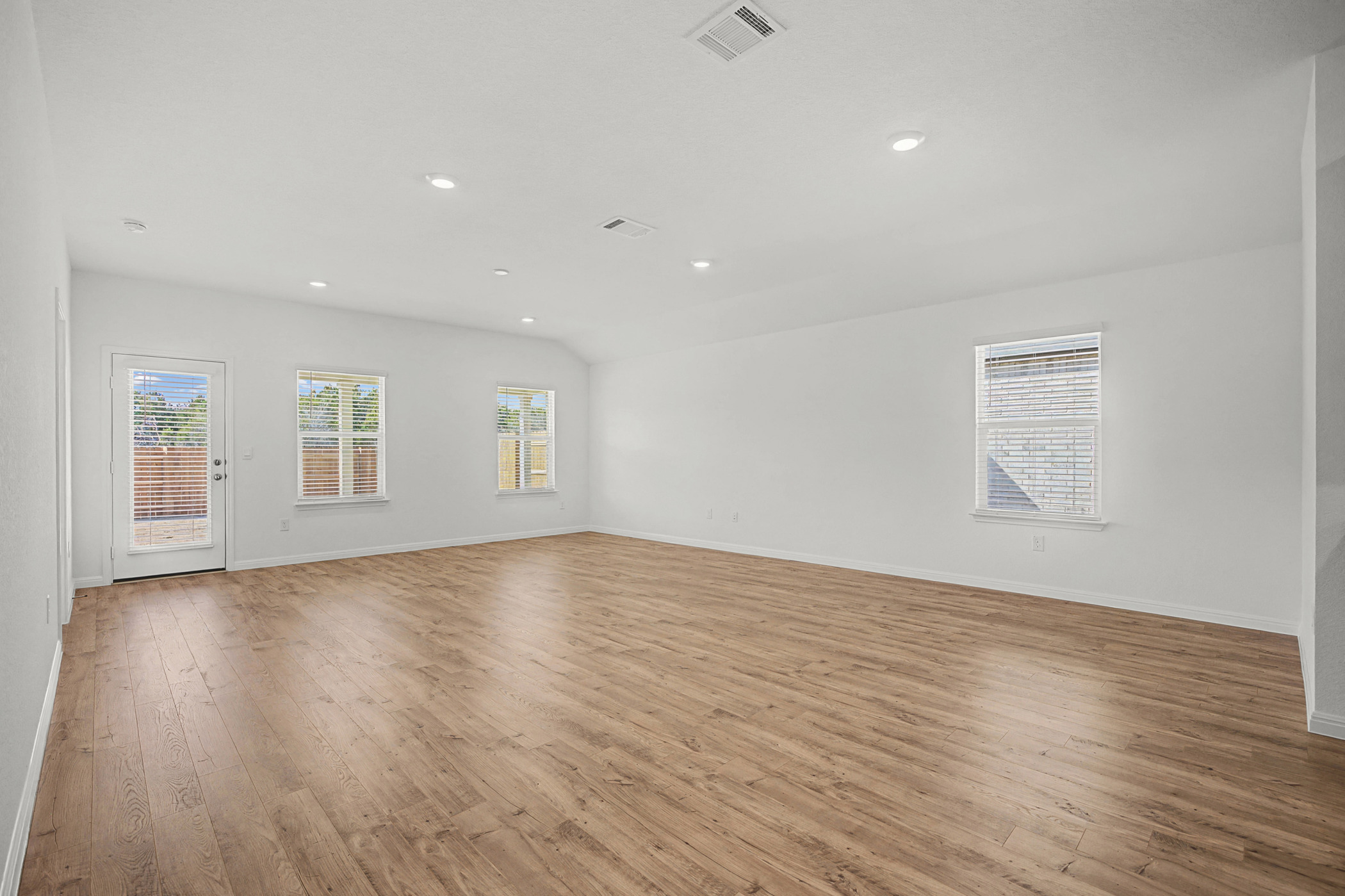 1932 Bandito Bluff Pass Leander, TX 78641 - Photo 7 of 21 a view of an empty room with wooden floor and a window