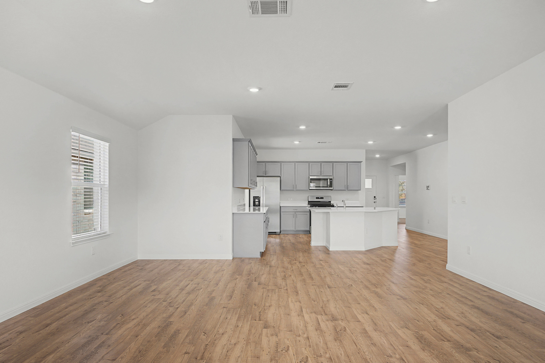 1932 Bandito Bluff Pass Leander, TX 78641 - Photo 21 of 21 a open kitchen with white cabinets and wooden floor