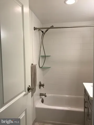 a bathroom with a bath tub with a shower