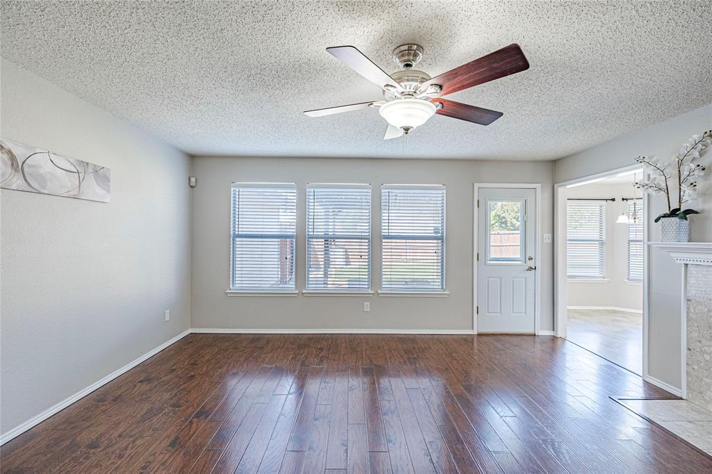 1805 Creek Crossing Garland, TX 75040 - Photo 18 of 39 a view of an empty room with wooden floor and a window
