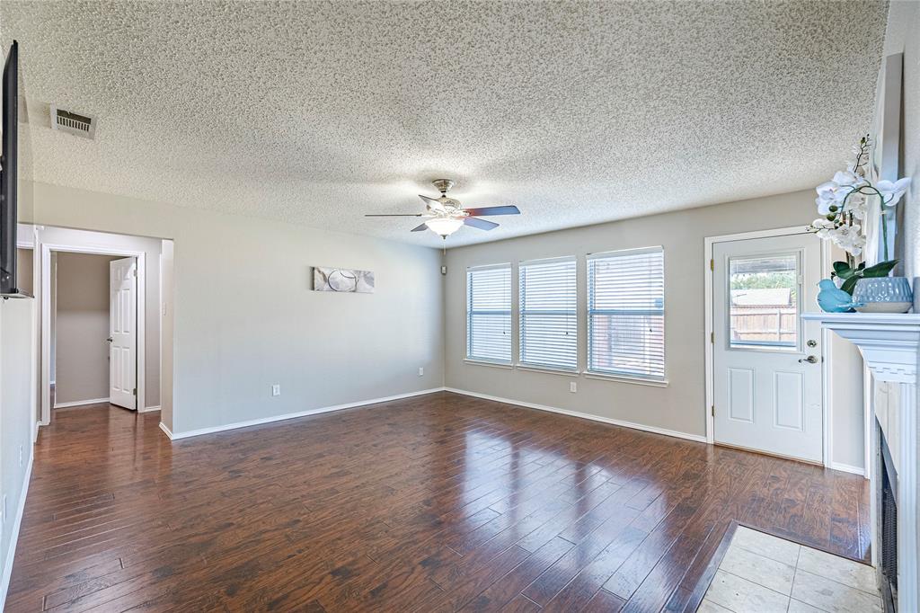 1805 Creek Crossing Garland, TX 75040 - Photo 19 of 39 a view of an empty room with a window and wooden floor