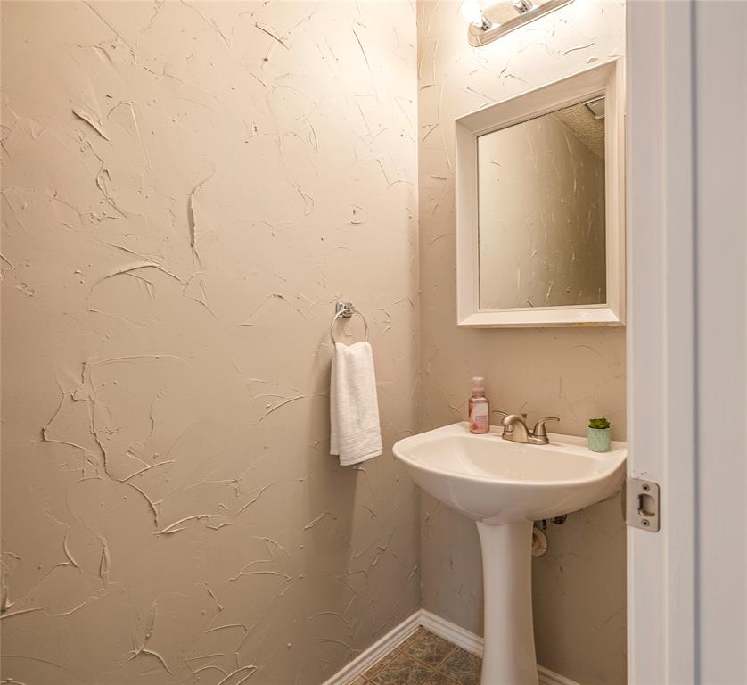 1805 Creek Crossing Garland, TX 75040 - Photo 22 of 39 a bathroom with a sink and mirror