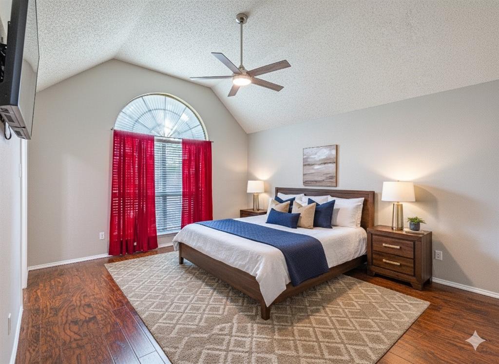 1805 Creek Crossing Garland, TX 75040 - Photo 23 of 39 a bedroom with a large bed and a chandelier
