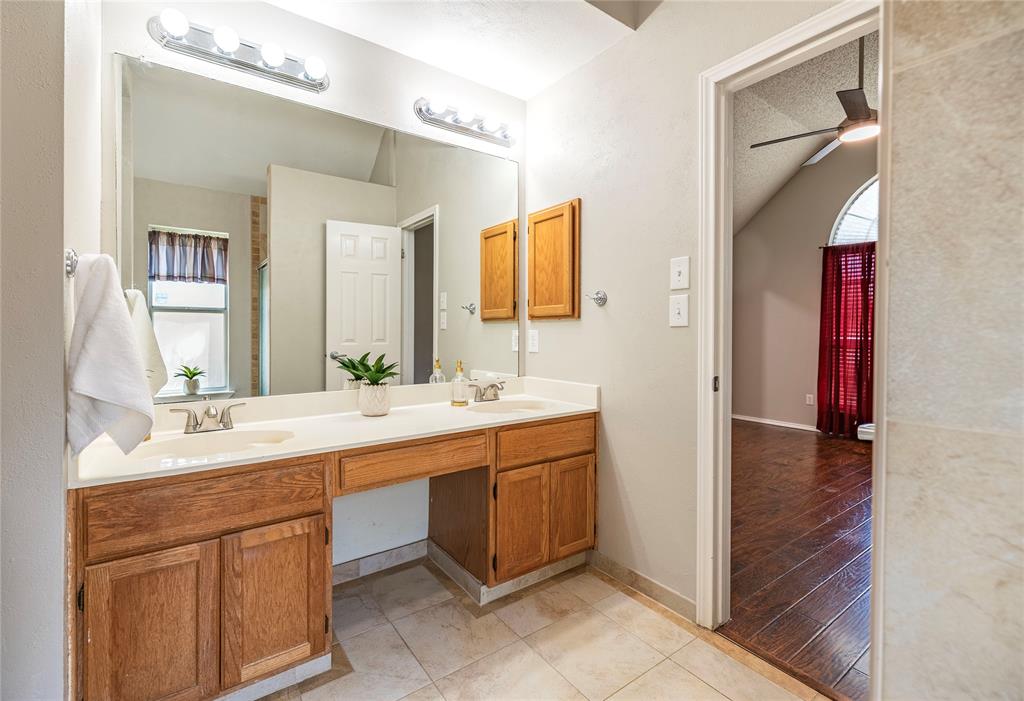 1805 Creek Crossing Garland, TX 75040 - Photo 27 of 39 a bathroom with a double vanity sink and mirror