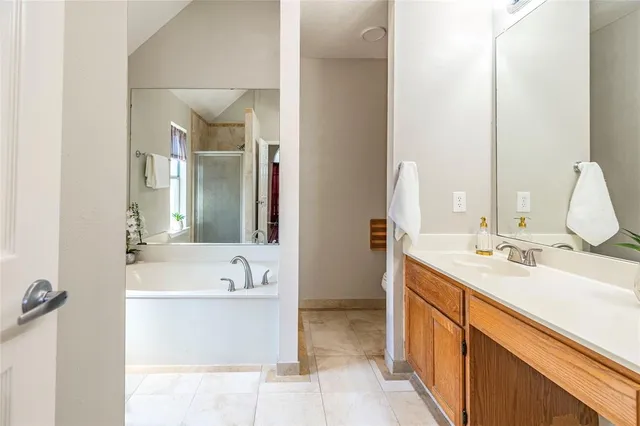 a bathroom with a tub sink and mirror