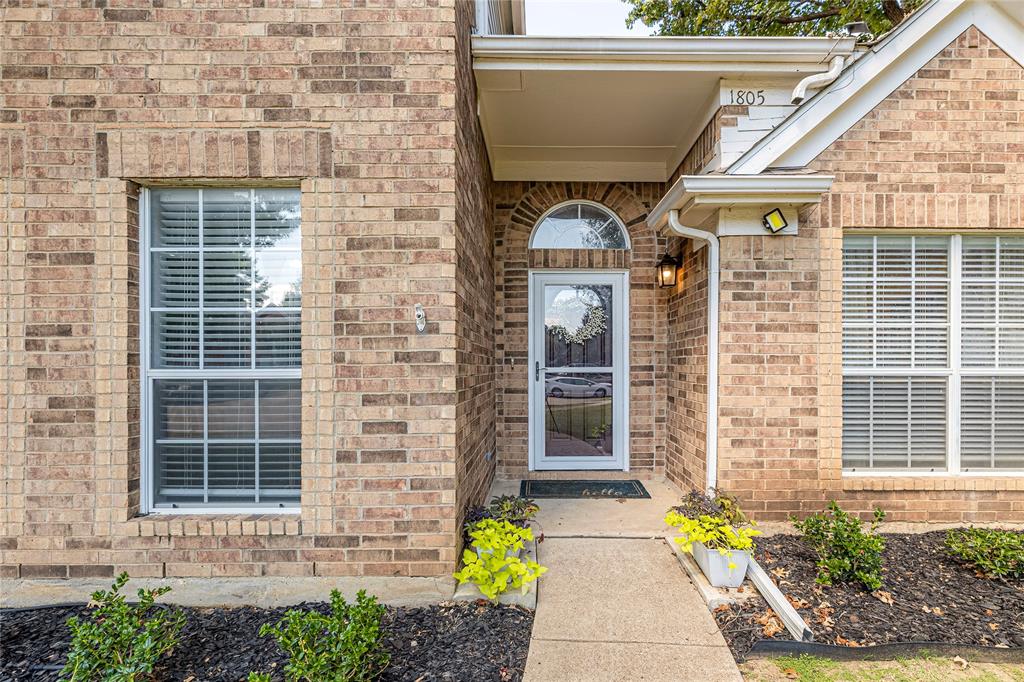 1805 Creek Crossing Garland, TX 75040 - Photo 3 of 39 a front view of a house with outdoor seating