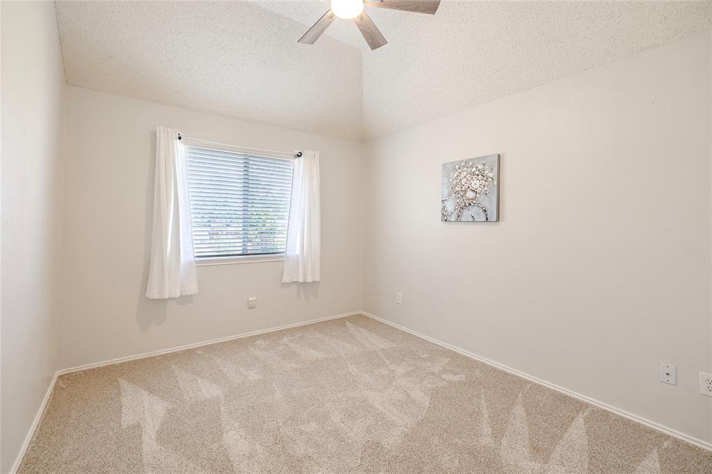 1805 Creek Crossing Garland, TX 75040 - Photo 33 of 39 an empty room with a window and a fan