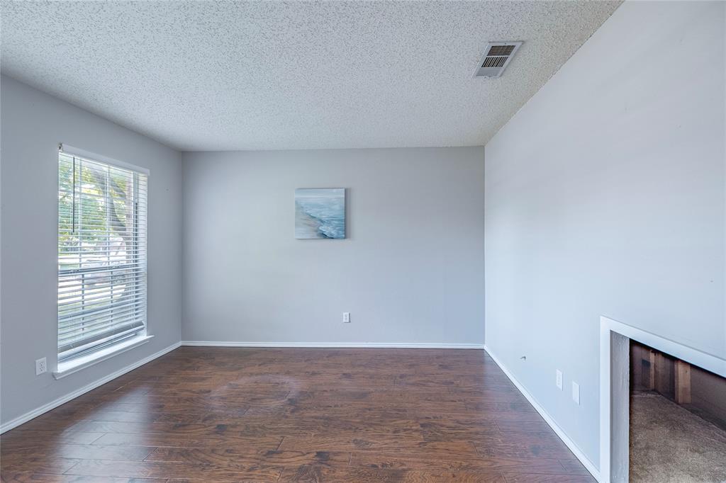 1805 Creek Crossing Garland, TX 75040 - Photo 7 of 39 a view of an empty room with wooden floor and a window