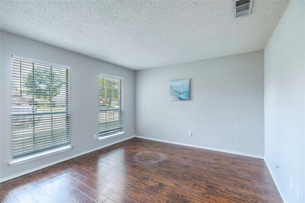1805 Creek Crossing Garland, TX 75040 - Photo 8 of 39 an empty room with wooden floor and windows