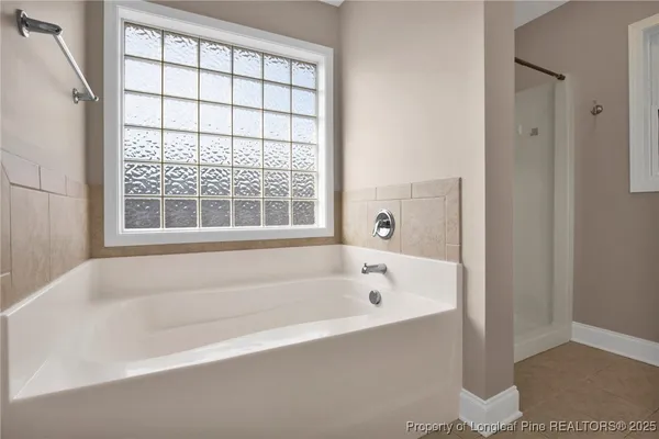 a white bath tub sitting next to a window