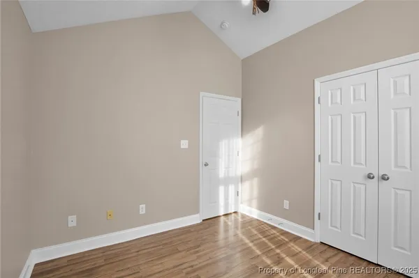 a view of an empty room with wooden floor