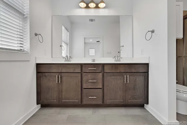 a bathroom with a sink vanity and mirror