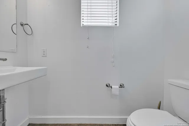 a bathroom with a toilet and a sink