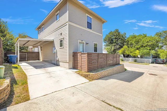 a view of house with backyard and tree