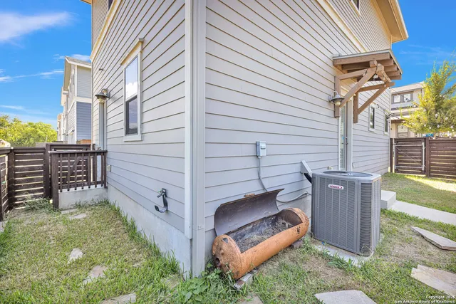 a view of a backyard with wooden fence