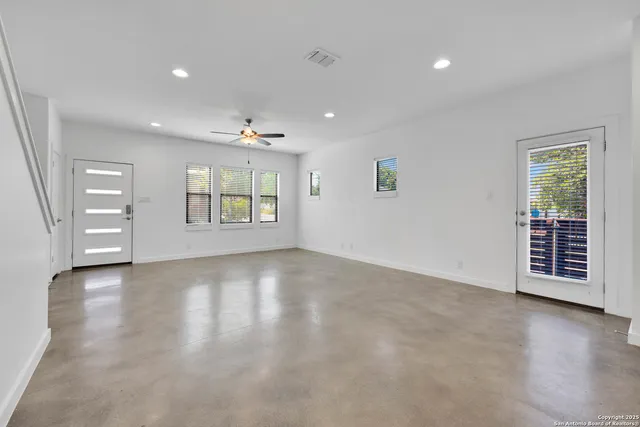 an empty room with windows and closet