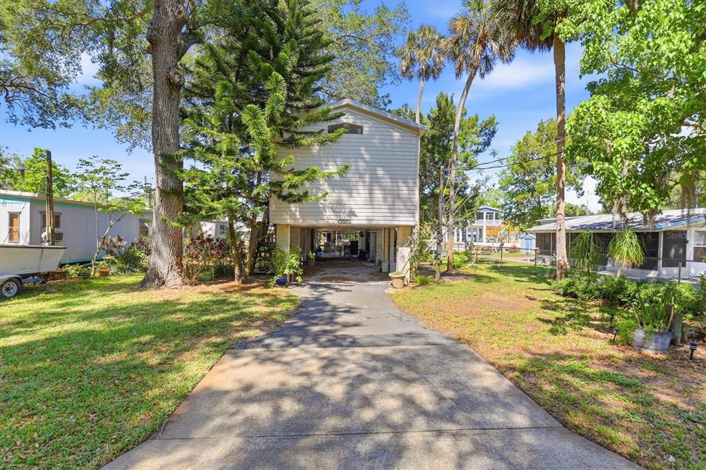6169 Waverly Road Weeki Wachee, FL 34607 - Photo 2 of 51 a front view of a house with a yard and trees