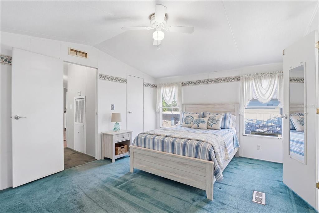 6169 Waverly Road Weeki Wachee, FL 34607 - Photo 33 of 51 a bedroom with a bed and a chandelier