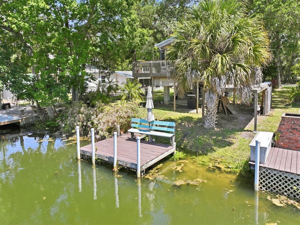 6169 Waverly Road Weeki Wachee, FL 34607 - Photo 9 of 51 a swimming pool with outdoor seating and yard