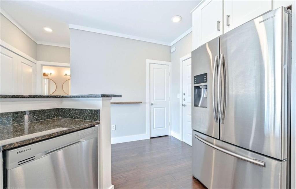 821 Ralph McGill Boulevard Northeast, Unit 2405 Atlanta, GA 30306 - Photo 4 of 12 a kitchen with stainless steel appliances granite countertop a refrigerator and a sink