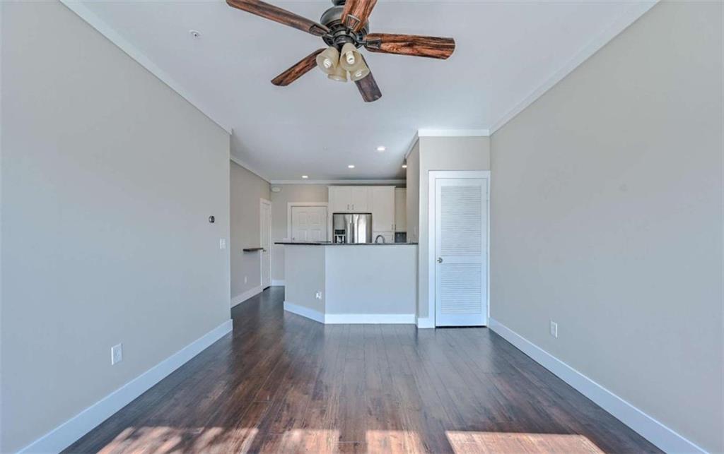821 Ralph McGill Boulevard Northeast, Unit 2405 Atlanta, GA 30306 - Photo 7 of 12 a view of a kitchen with wooden floor and a ceiling fan