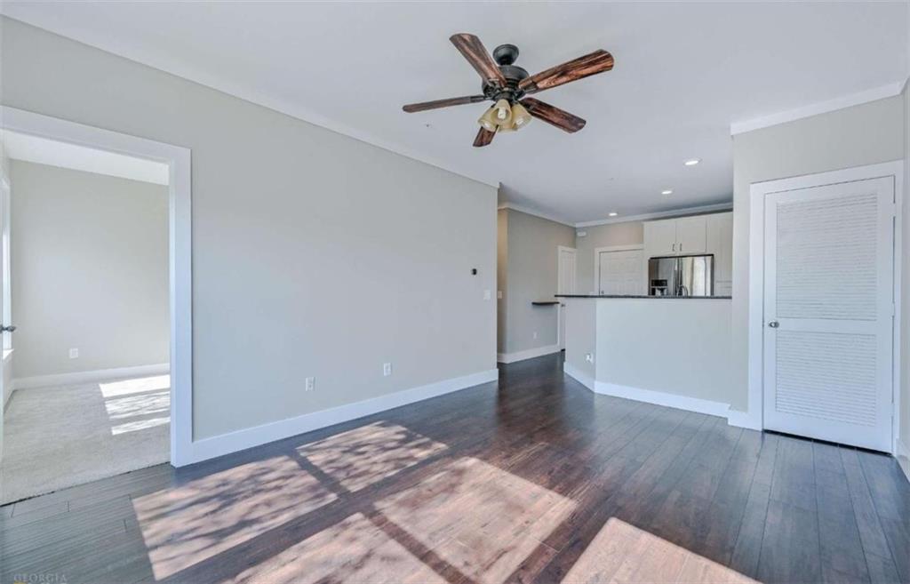 821 Ralph McGill Boulevard Northeast, Unit 2405 Atlanta, GA 30306 - Photo 8 of 12 a view of a kitchen with wooden floor and a ceiling fan
