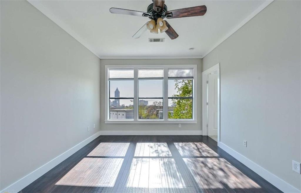 821 Ralph McGill Boulevard Northeast, Unit 2405 Atlanta, GA 30306 - Photo 9 of 12 wooden floor in an empty room with a window