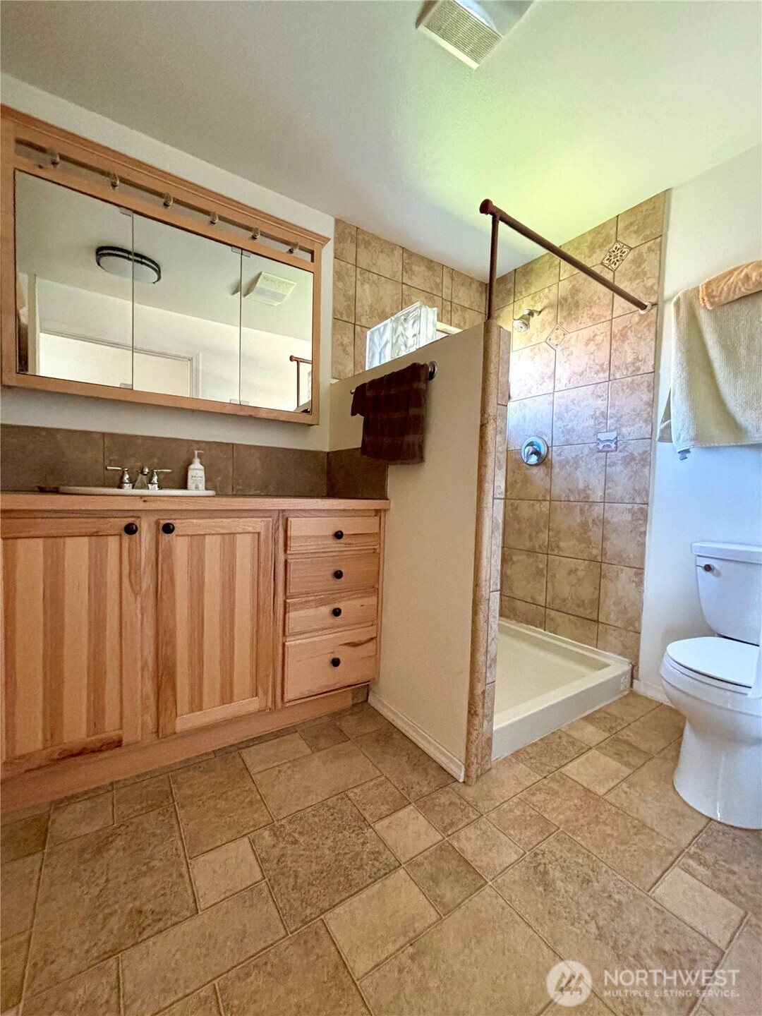 20548 Northeast 22nd Road Marlin, WA 98832 - Photo 13 of 26 a bathroom with a glass shower door and a sink