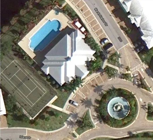 an aerial view of a house with a yard and potted plants