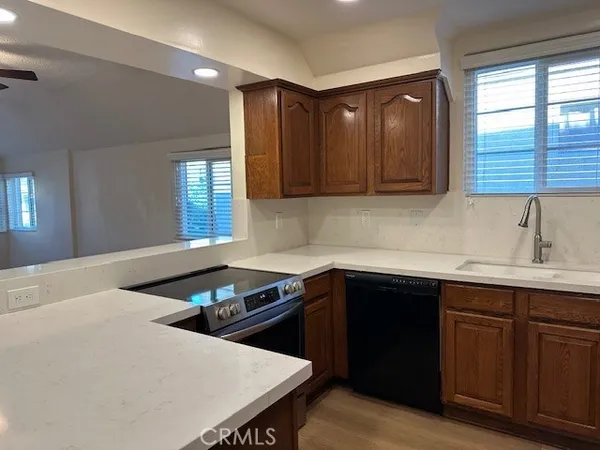 a kitchen with a sink a window and cabinets