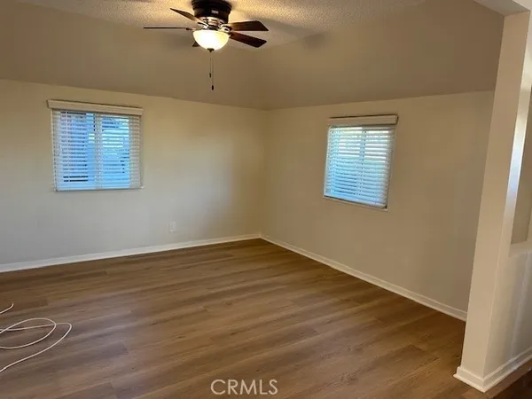 a view of a room with wooden floor and fan