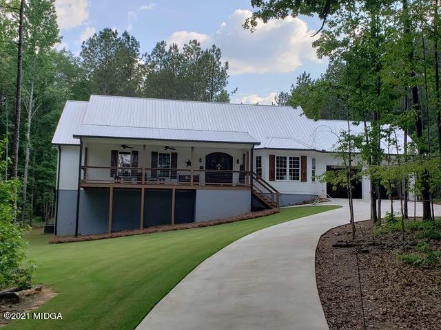 725 Taylor Road Juliette, GA 31046 - Photo 1 of 62 a front view of a house with a garden and yard
