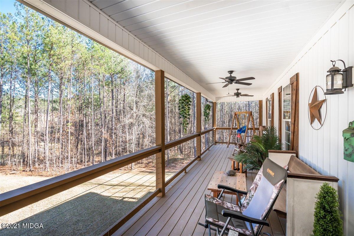 725 Taylor Road Juliette, GA 31046 - Photo 2 of 62 a view of a porch with furniture and wooden floor