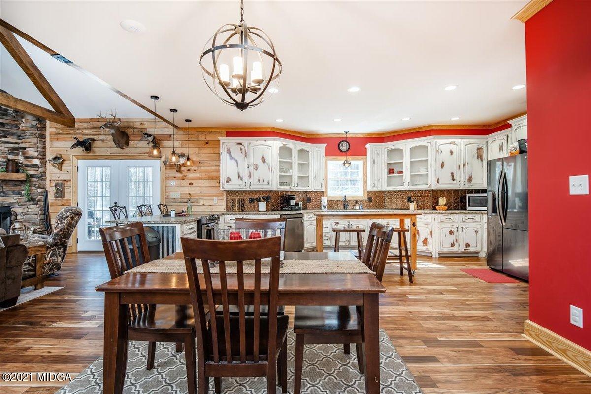 725 Taylor Road Juliette, GA 31046 - Photo 12 of 62 a view of a dining room with furniture window and wooden floor