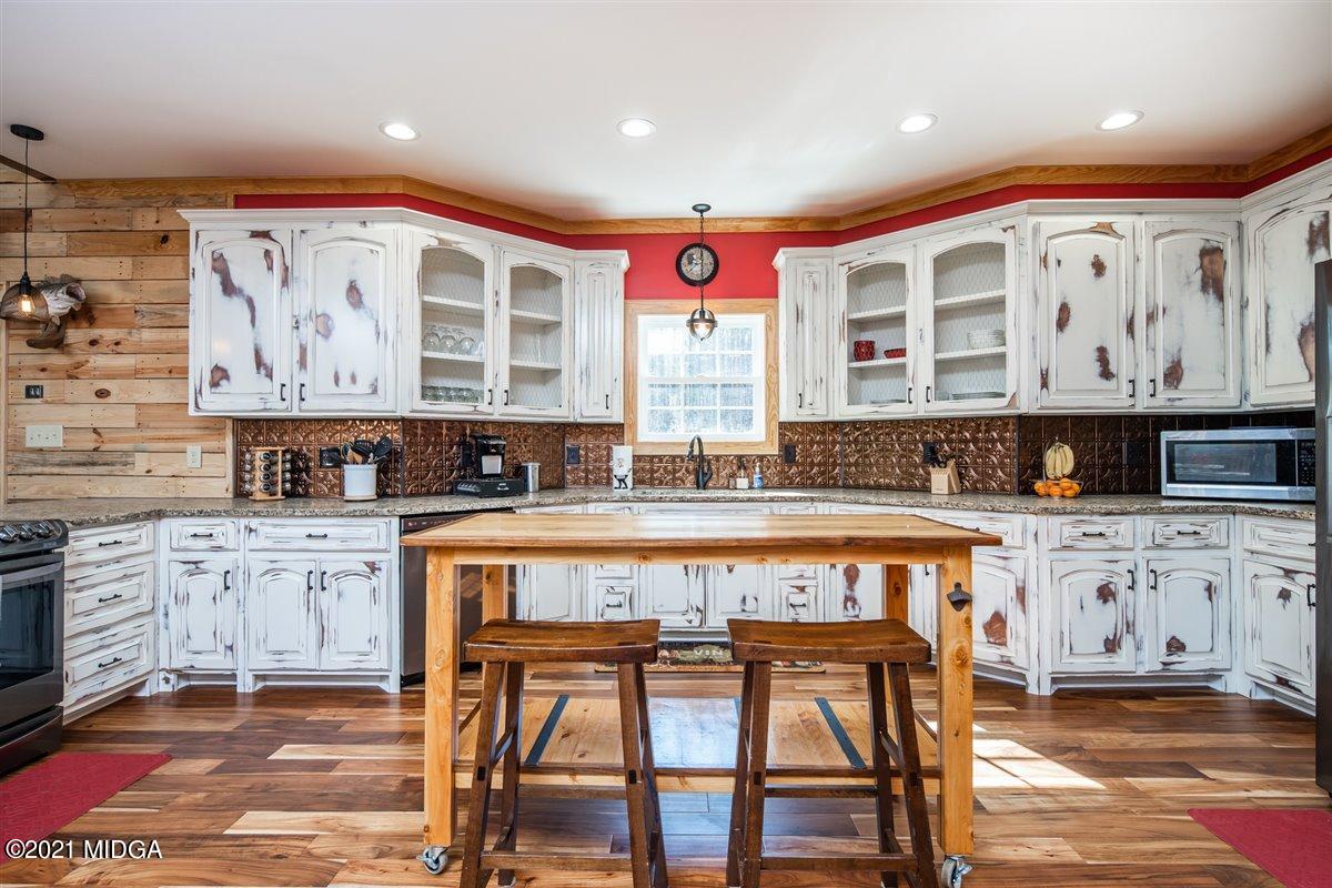 725 Taylor Road Juliette, GA 31046 - Photo 15 of 62 a large kitchen with stainless steel appliances granite countertop a stove a sink and a refrigerator