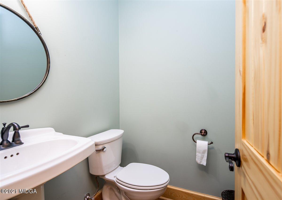 725 Taylor Road Juliette, GA 31046 - Photo 19 of 62 a white toilet sitting next to a bathroom sink