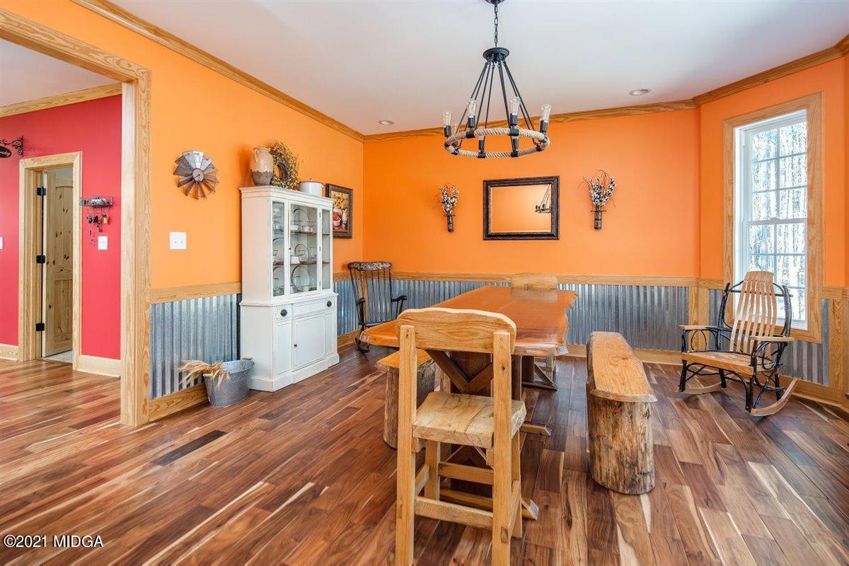 725 Taylor Road Juliette, GA 31046 - Photo 21 of 62 a dining room with furniture a chandelier and wooden floor