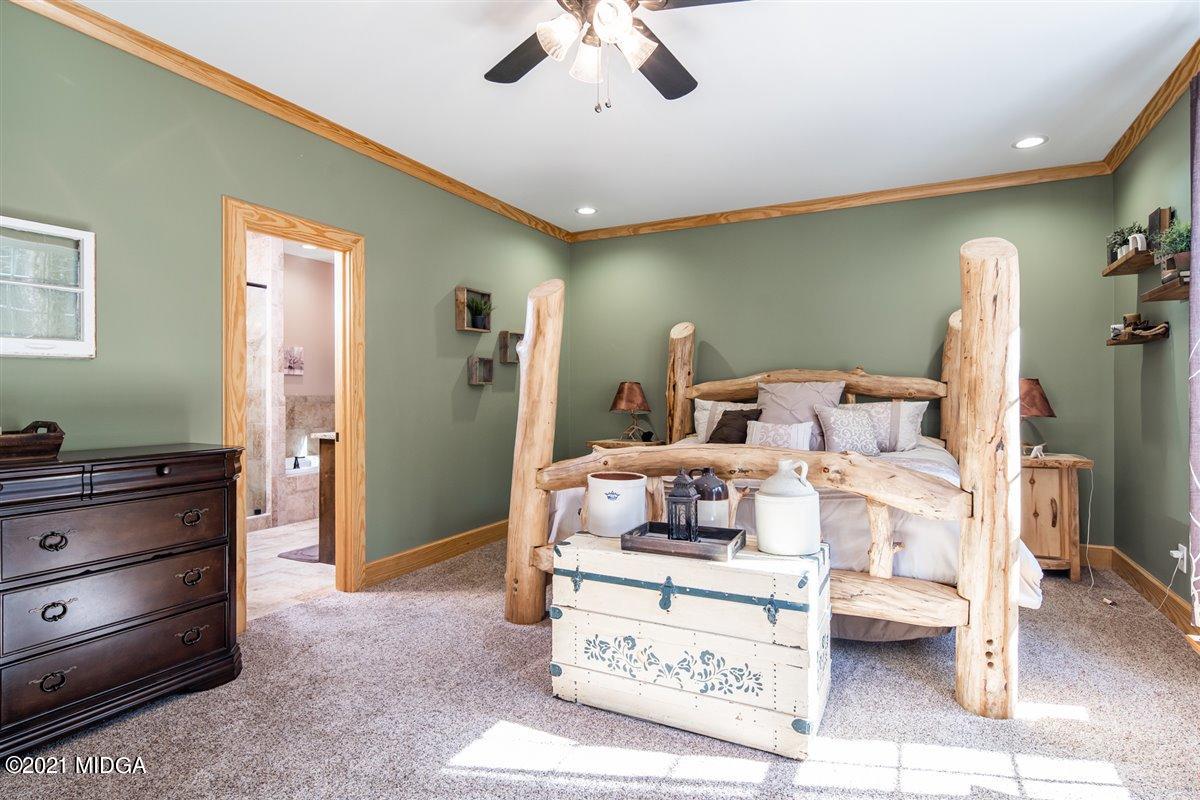 725 Taylor Road Juliette, GA 31046 - Photo 25 of 62 a bedroom with a bed and a chandelier